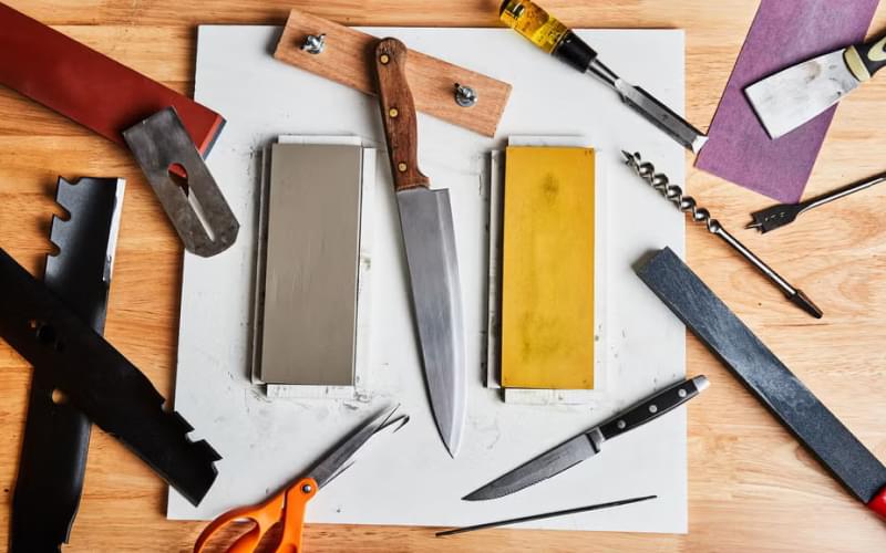 A tidy, well-lit workspace with various tools being sharpened.
